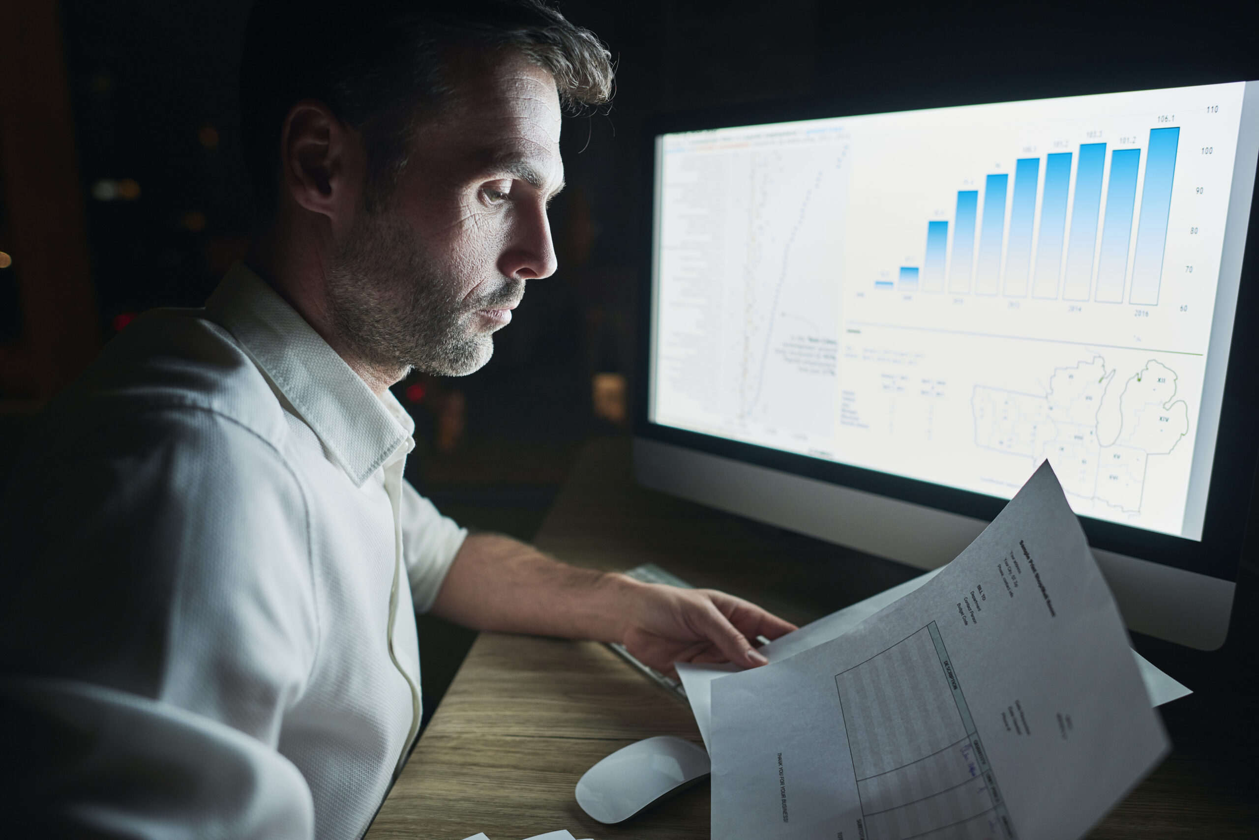 side view mature man analyzing documents night scaled